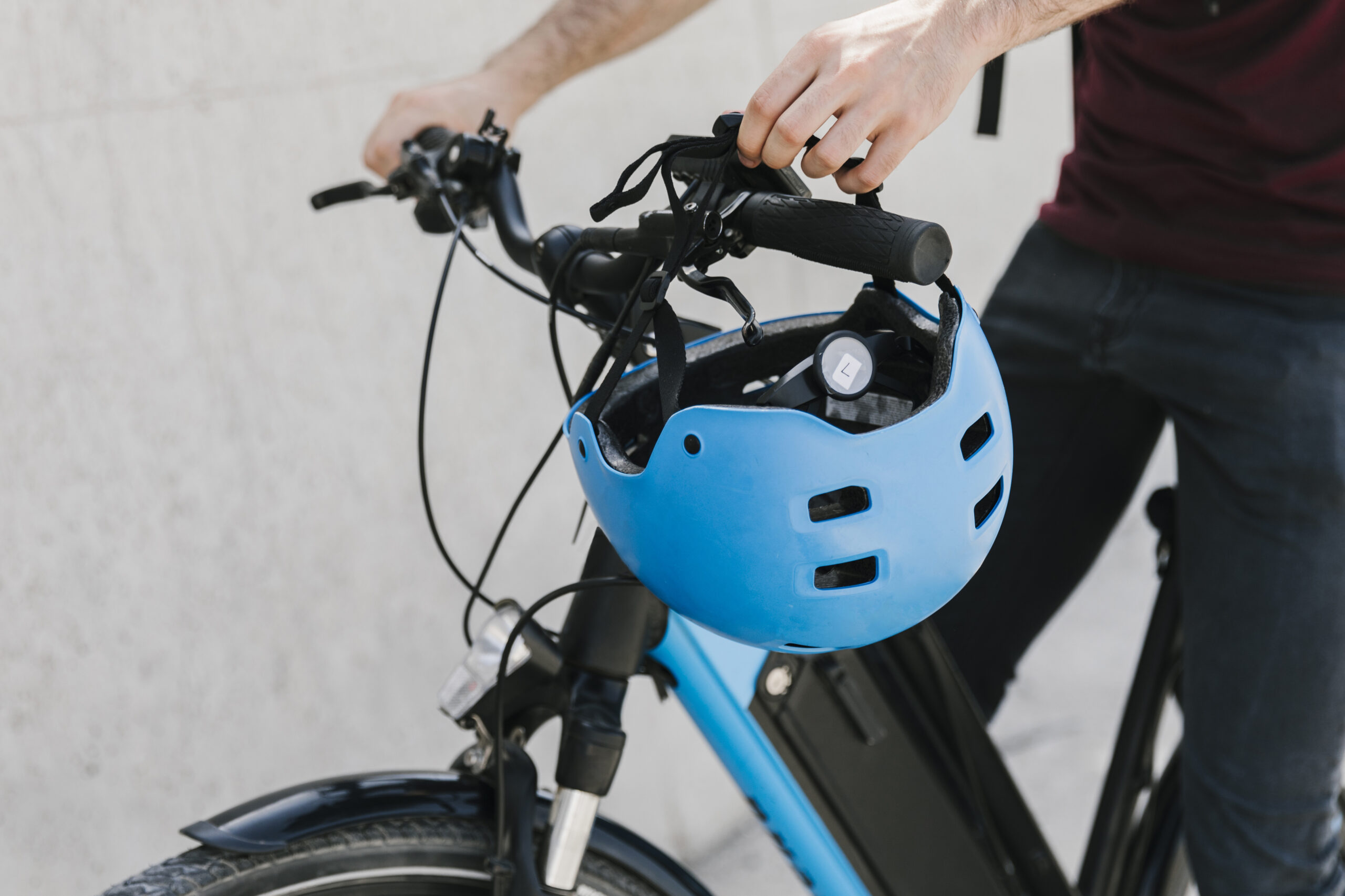 close-up-bicyclist-putting-helmet-bycicle-handle